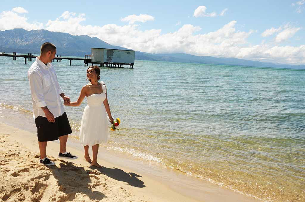 Couple walking along the shoreline of Regan Beach