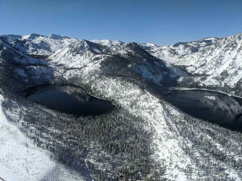 Aerial scene from the helicopter of the Sierra Nevada Mountains filled with snow
