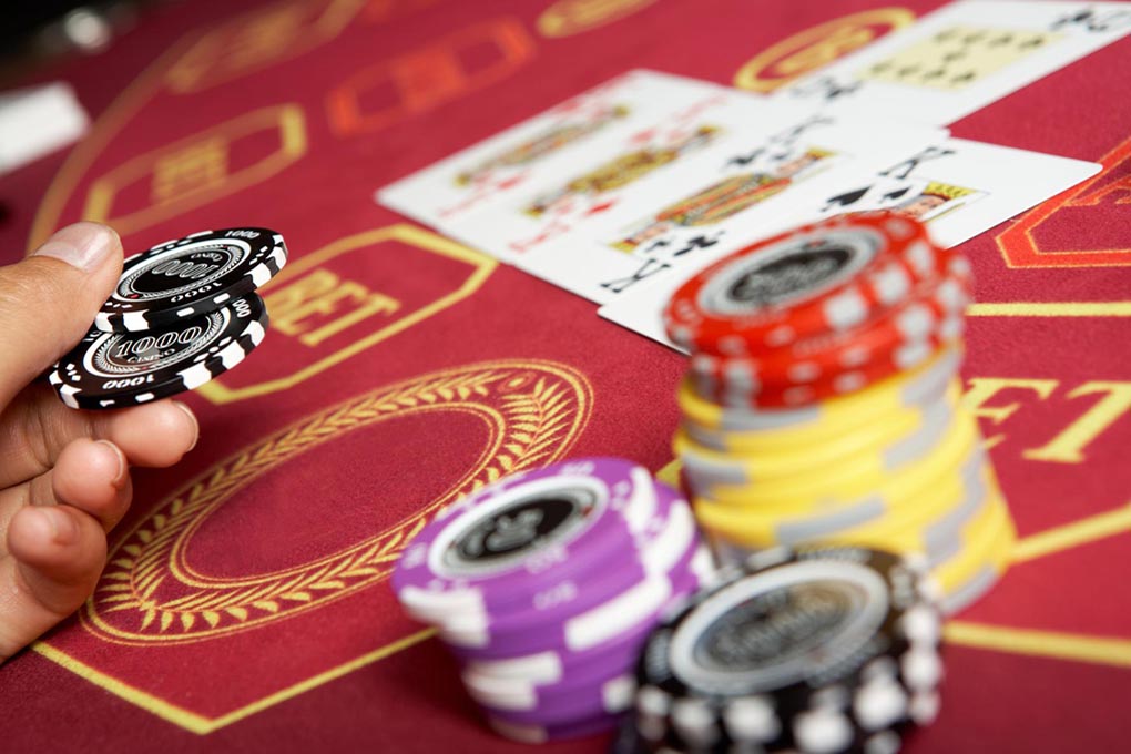 Gaming table with poker chips and playing cards.