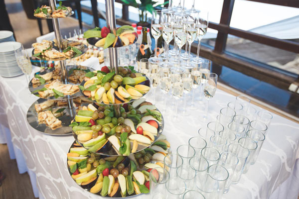 A display of buffet items on a table with glasses
