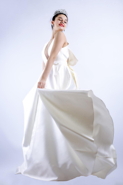 Bride models her wedding dress