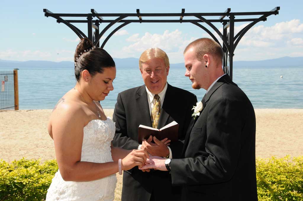 The bride and groom exchanging vows and rings