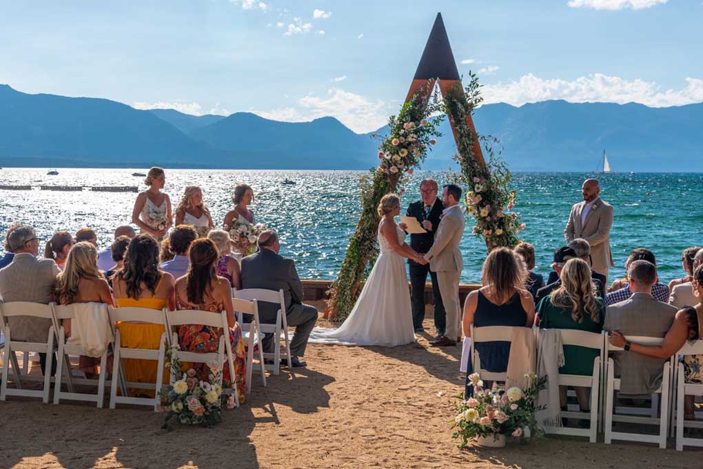 Pastor with couple under arch conducting the ritual