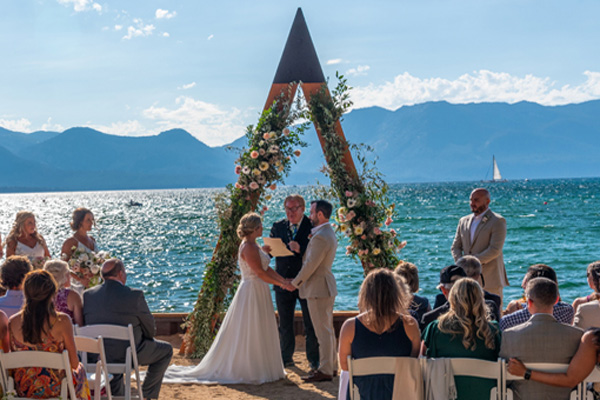 The marriage ritual is taking place under the arch by the waterside