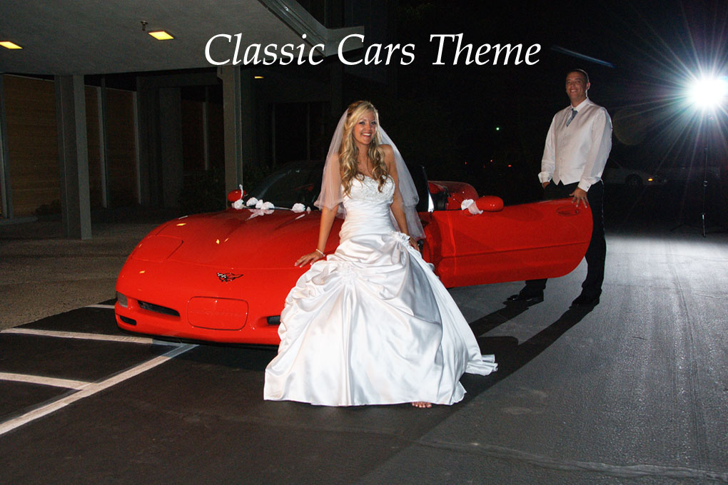 A bride in a bridal gown is sitting on the hood of a Corvette