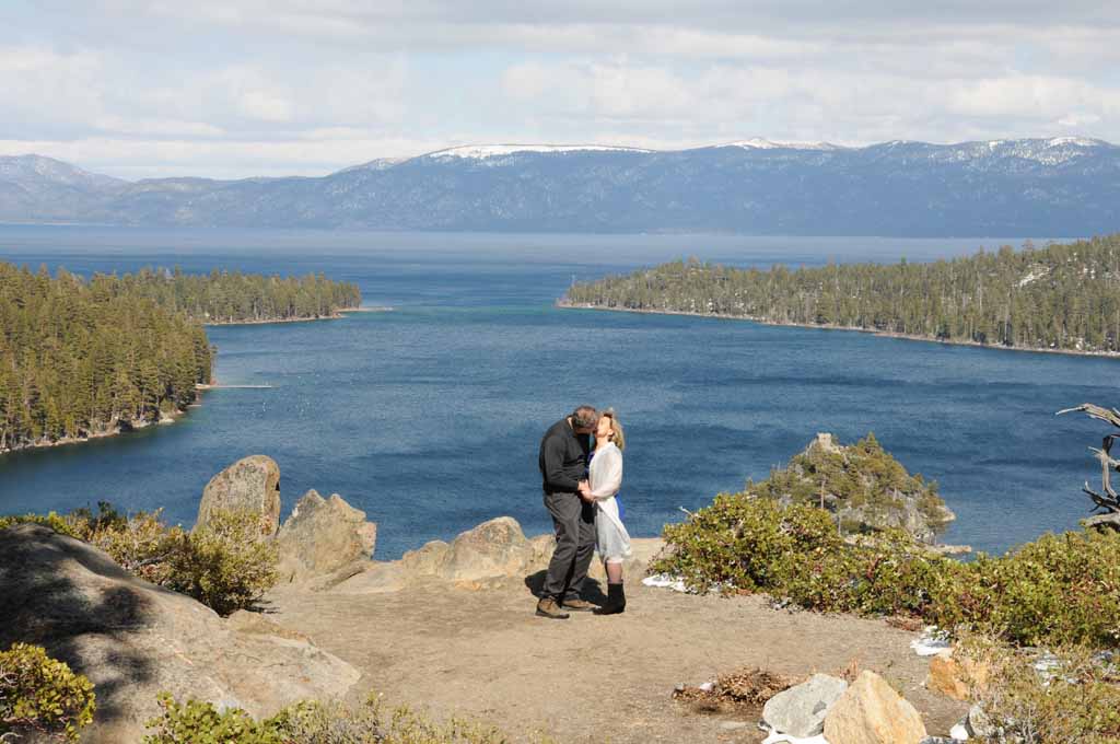 A couple after the marriage service celebrating at the precipice of Emerald Bay