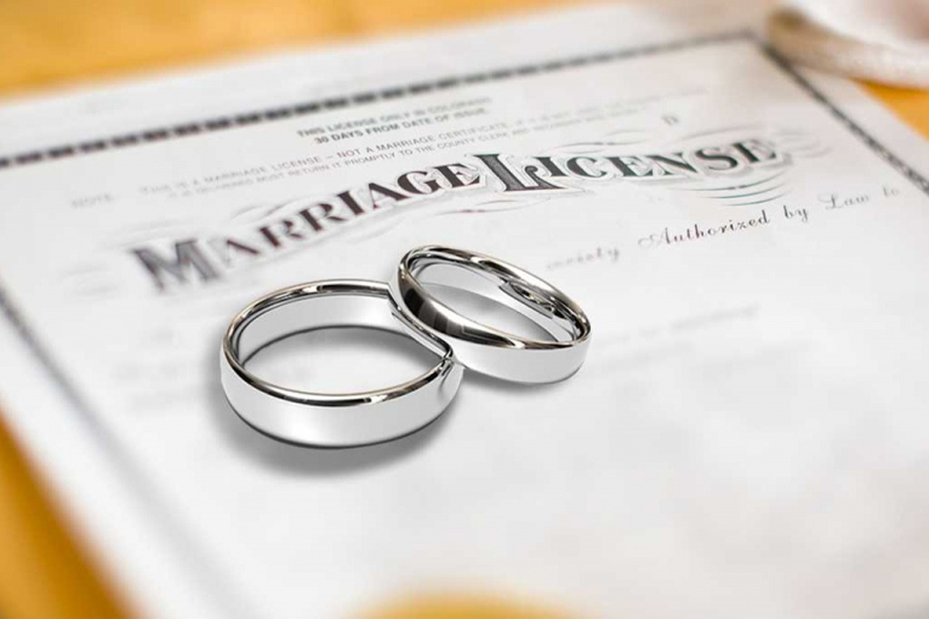 Image of a marriage license with wedding rings on it
