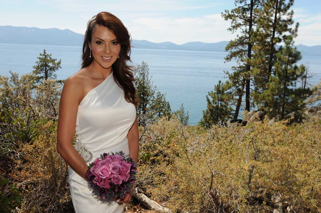 The bride poses while holding her bouquet
