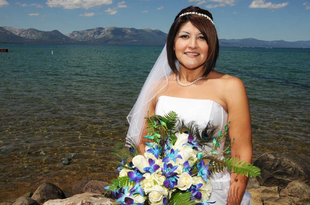 Formally dressed bride poses with beautiful bouquet