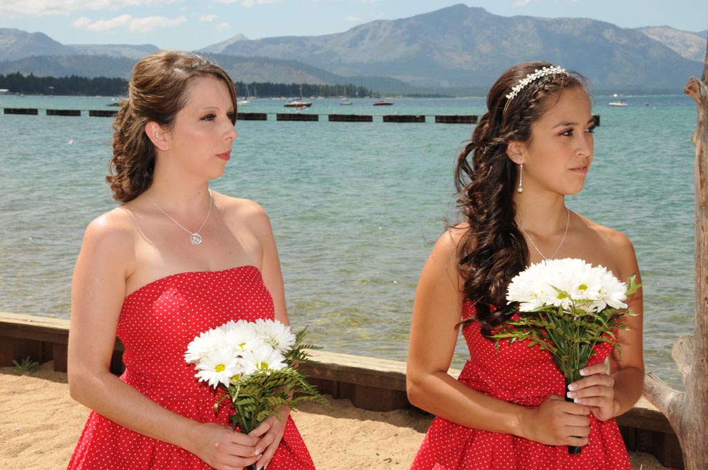 The bridesmaid and flower girl look intently as the wedding ceremony progresses