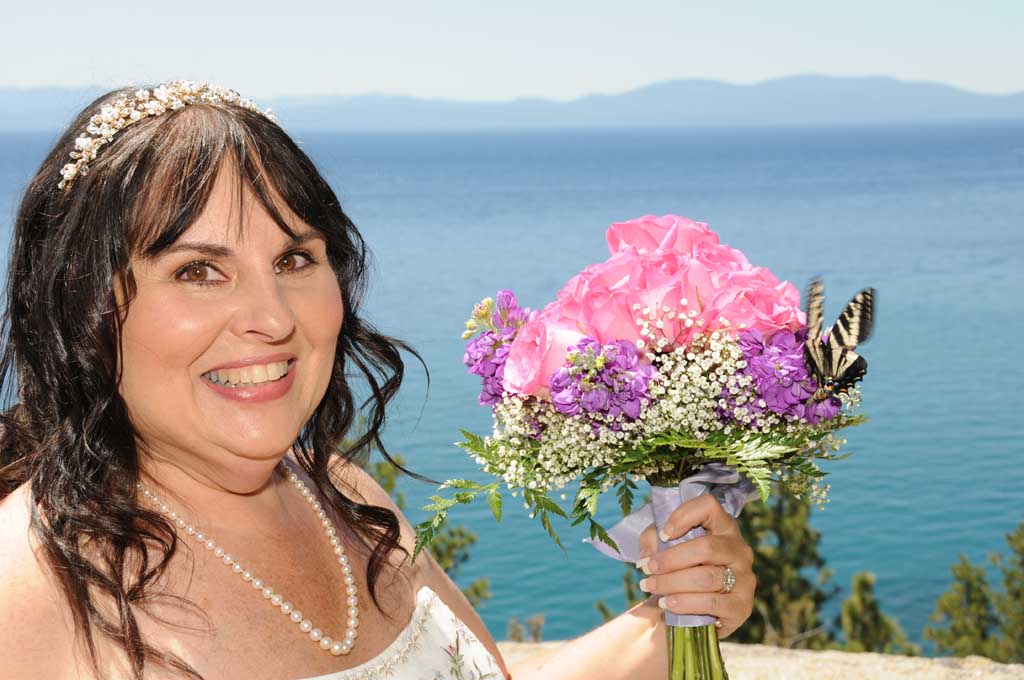 A butterfly lands on the bridal bouquet