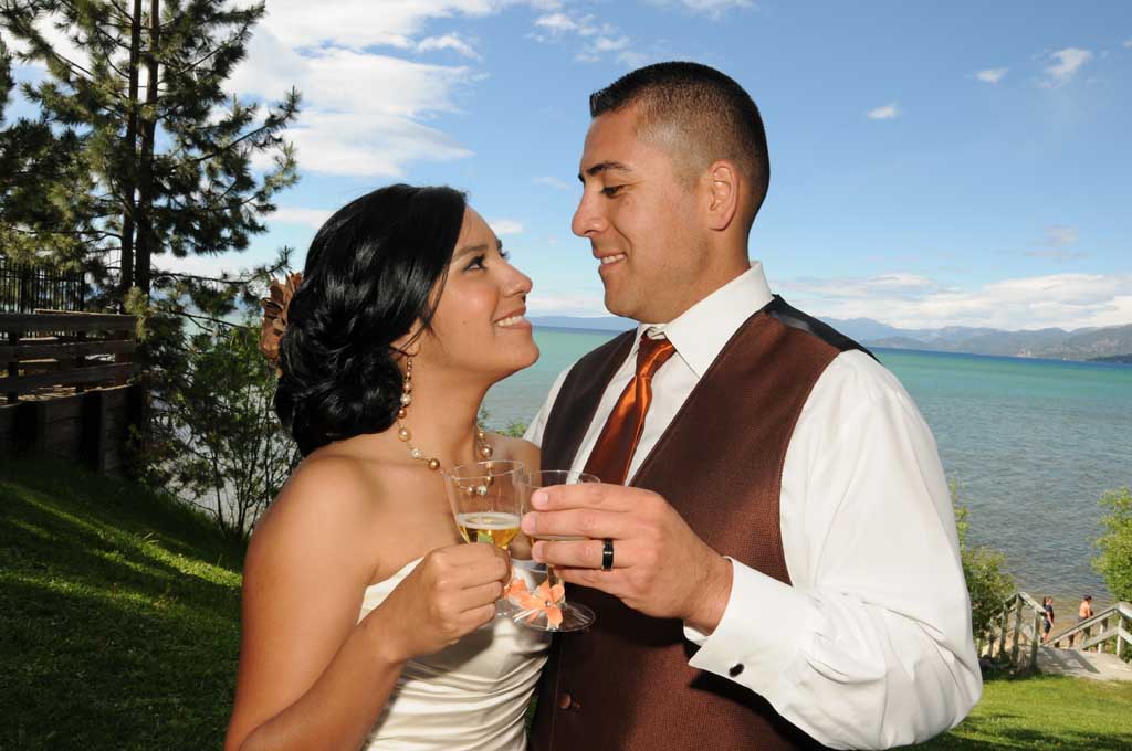 The new spouses clink their toasting glasses together