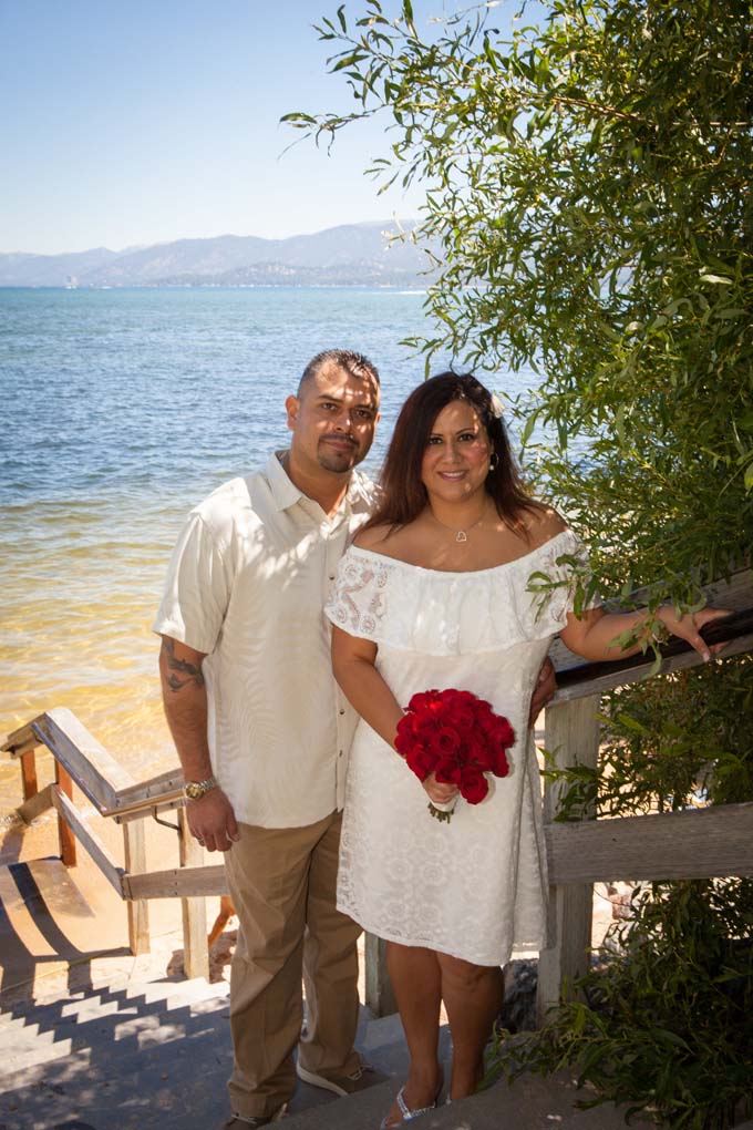 Posing on the stairs near the beach after their wedding service