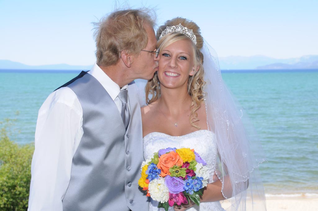 Father kisses the cheek of his daughter