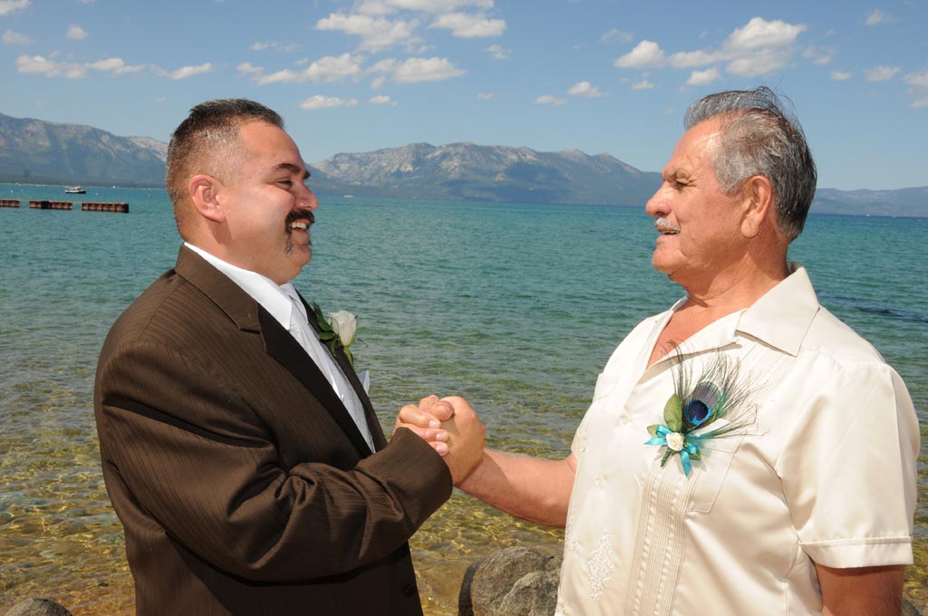 Dad congratulates his son with a handshake