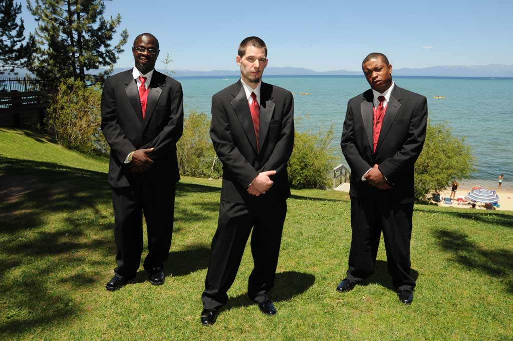 The groomsmen standing next to the groom