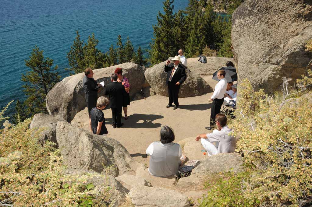 A group on the bluff of Logan Shoals watches the marriage service taking place