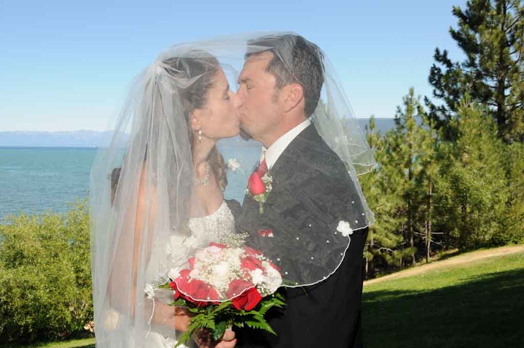 Husband and wife have their first kiss under the veil