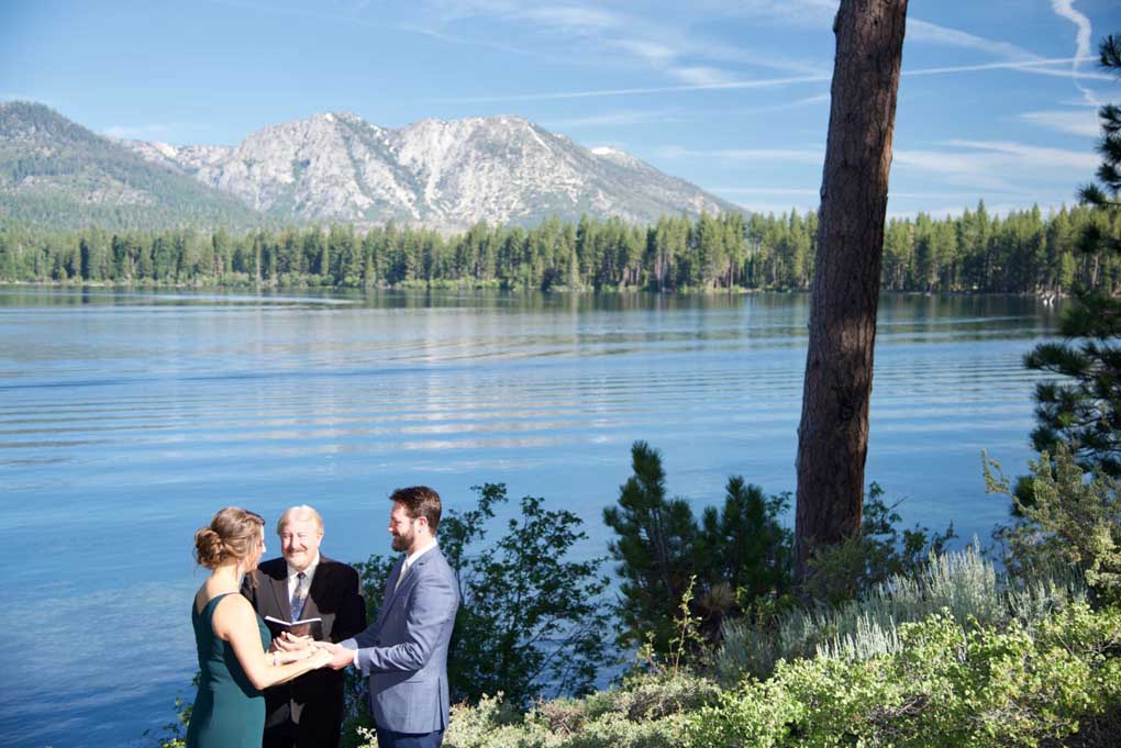 Minister conducting a wedding at the water's edge of Fallen Leaf Lake