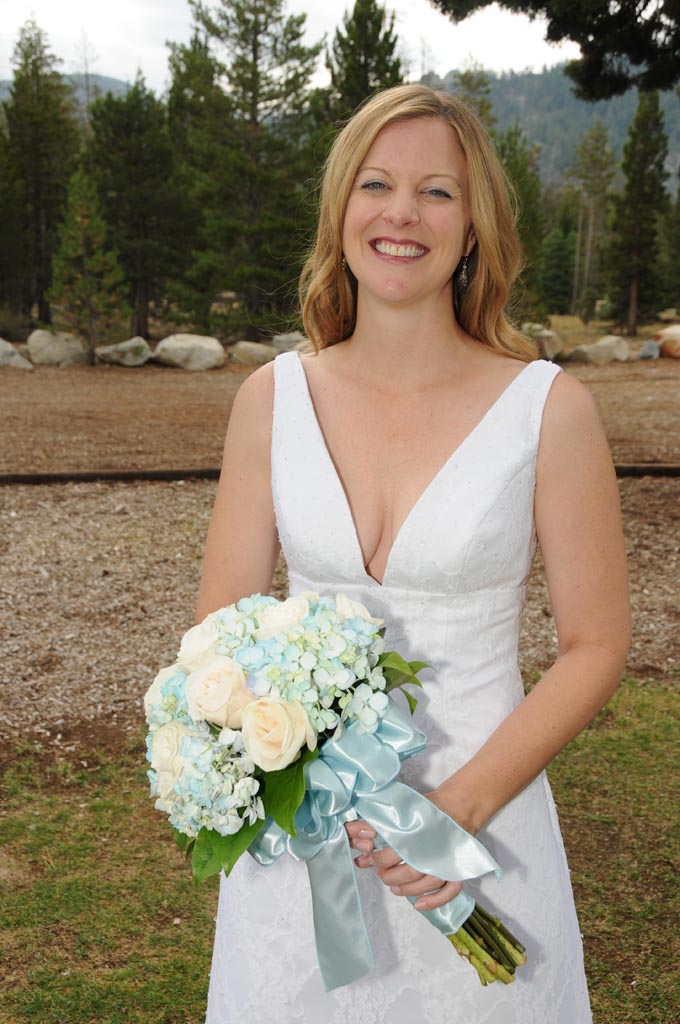 The bride smiles big as she gets ready to walk down the aisle of matrimony