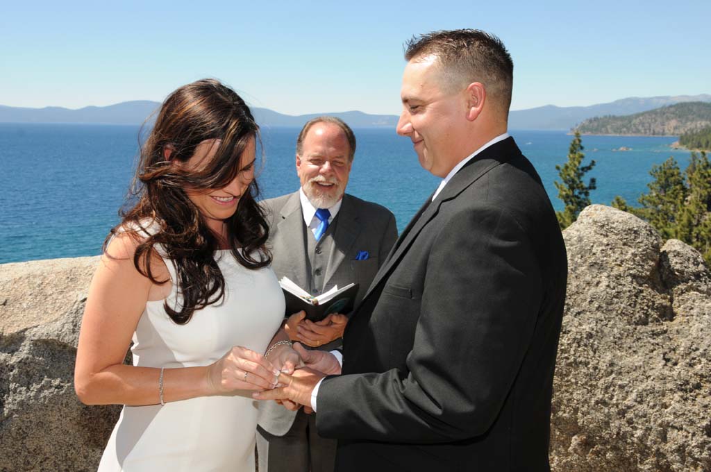 Bride places ring on groom's finger