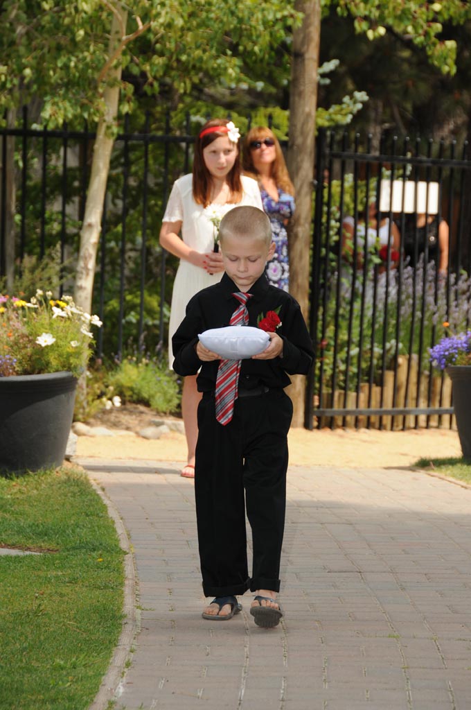The young ring bearer walking down the aisle