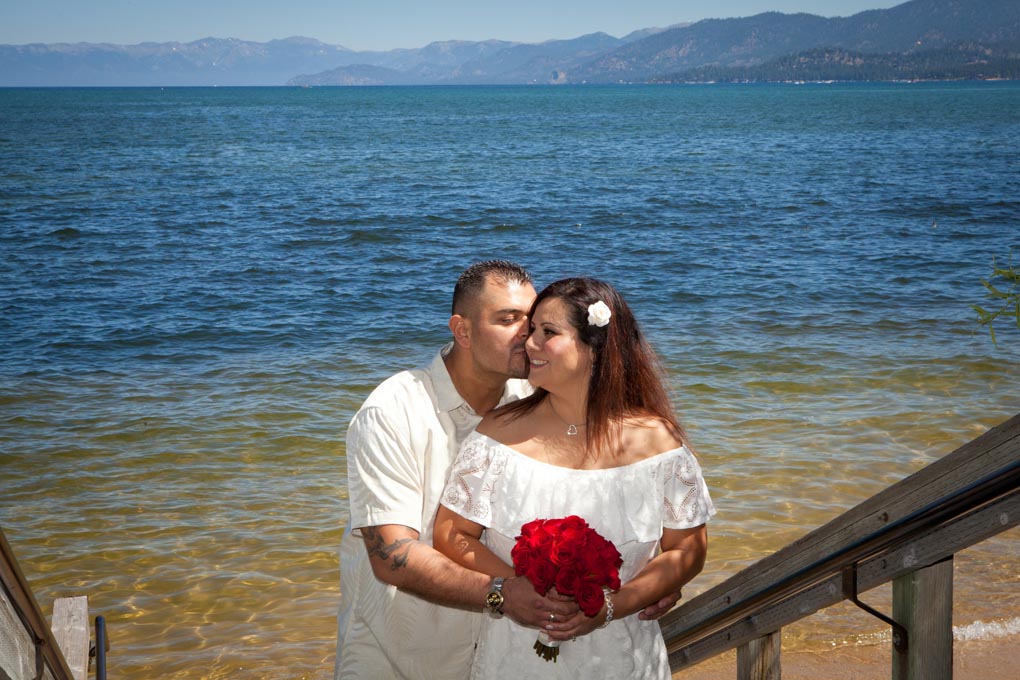 Groom kisses the cheek of his bride