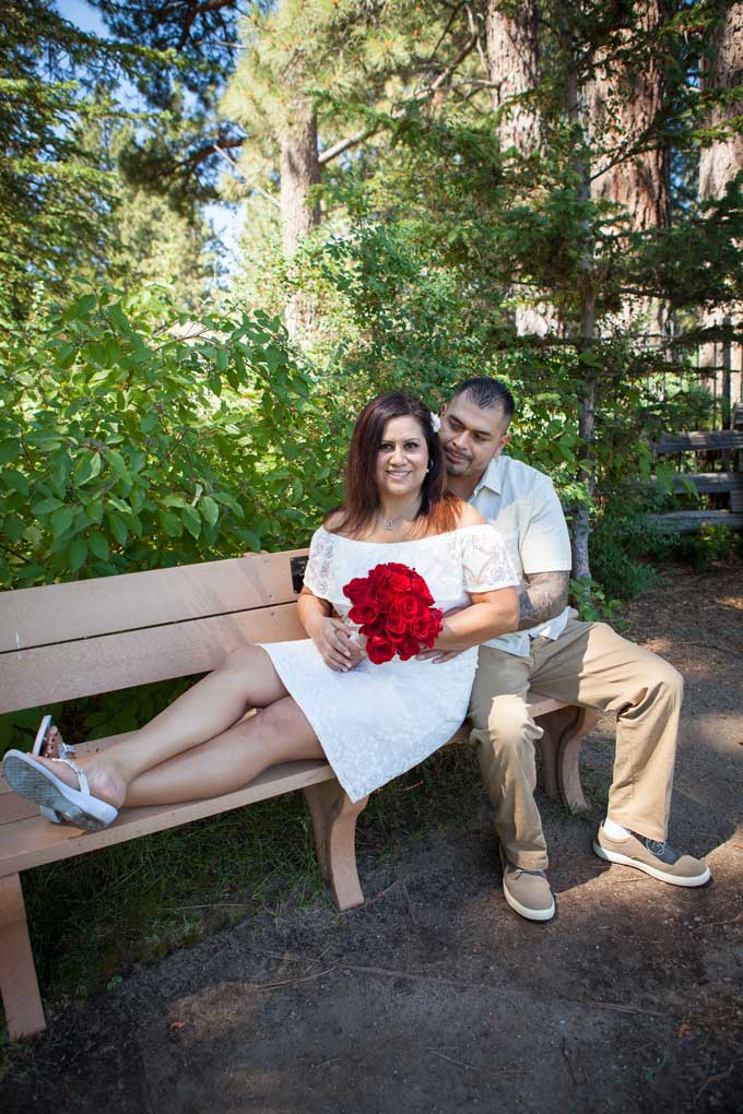 The newlyweds sitting on a park bench