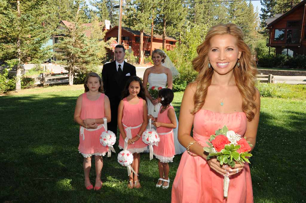 The maid of honer walking down the aisle as the processional begins
