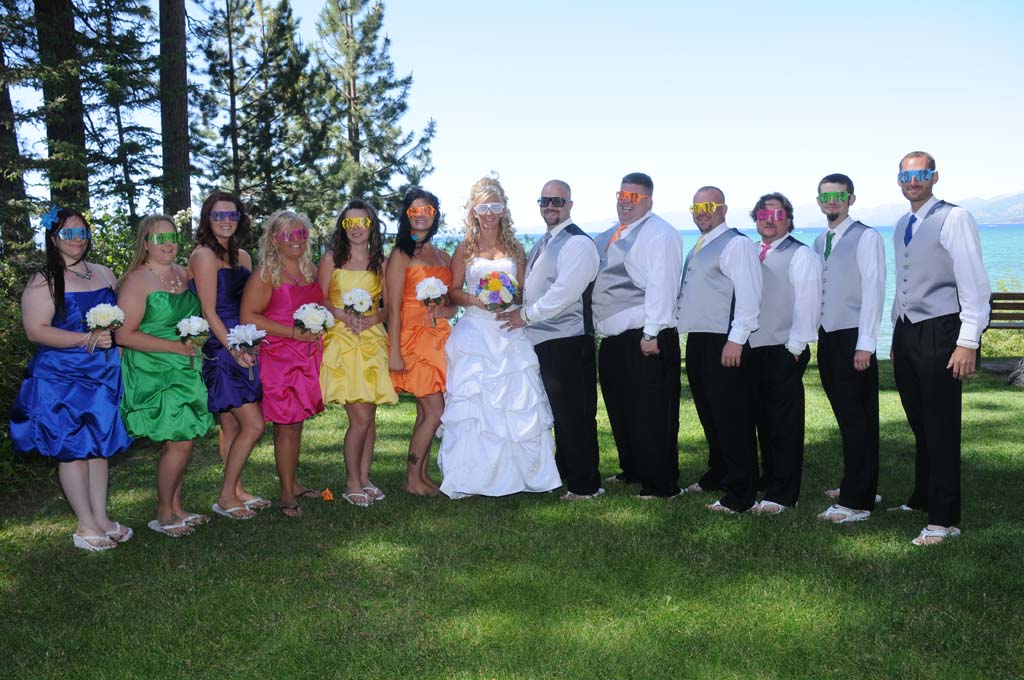 The bridal party posing with mask glasses covering their eyes