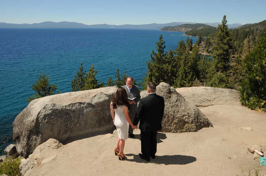 The minister conducting a wedding service on the bluff at Logan Shoals
