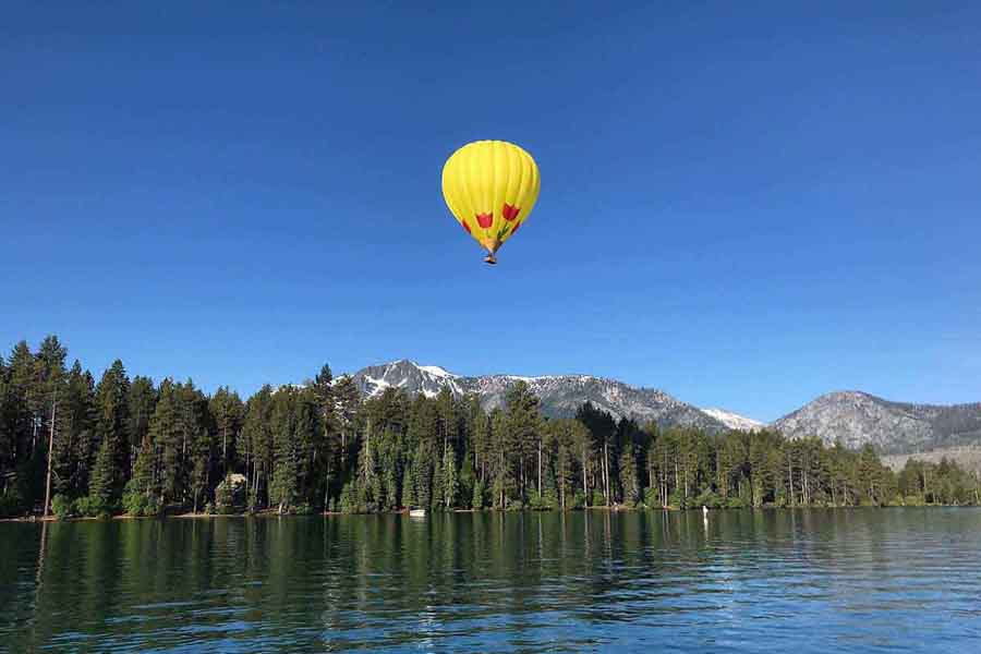 Hot air balloon floating above the mountaintops