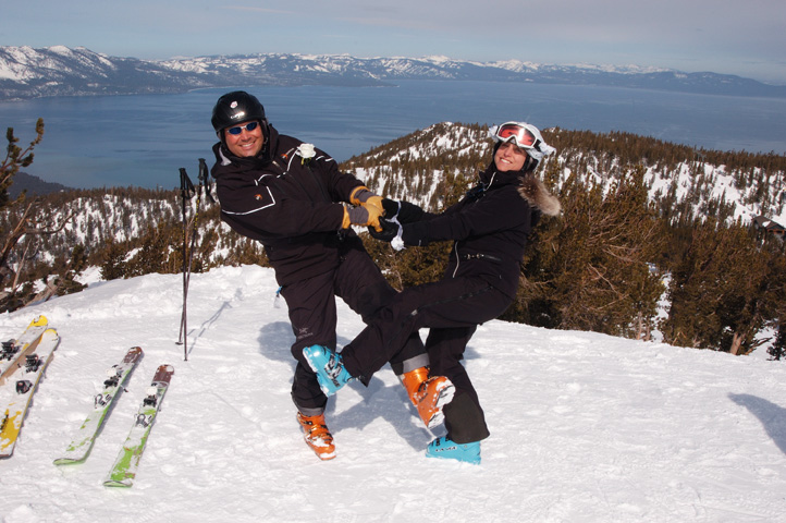 The couple strikes an acrobatic pose on their skis