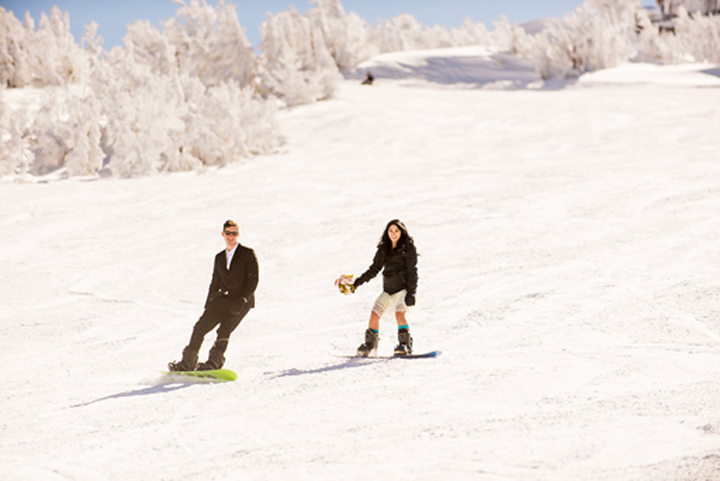 Snowboarding down the mountainside after being pronounced husband and wife