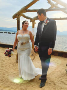 Newlyweds under the lakeside arch