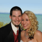 The newly married couple smile happily with their cheeks together