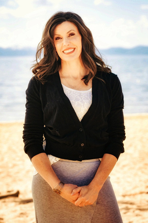 Reverend Tawni Janvrim posing on the beach.