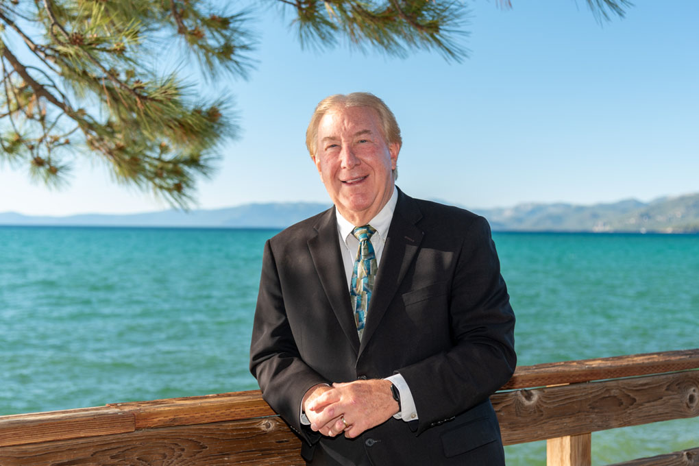 Pastor Rob Orr posing casually in a suit.