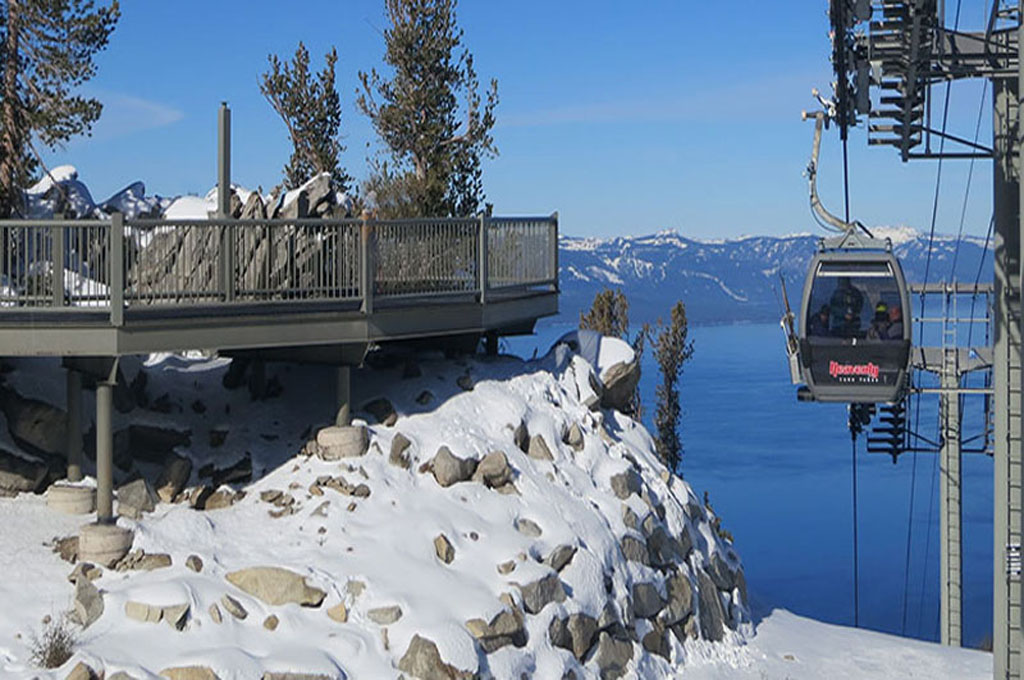 Gondola car with riders approaching the midway observation deck.