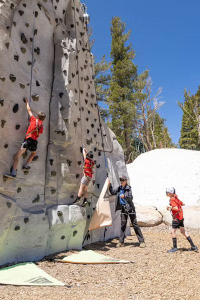 Several climbers ascending the rock wall.